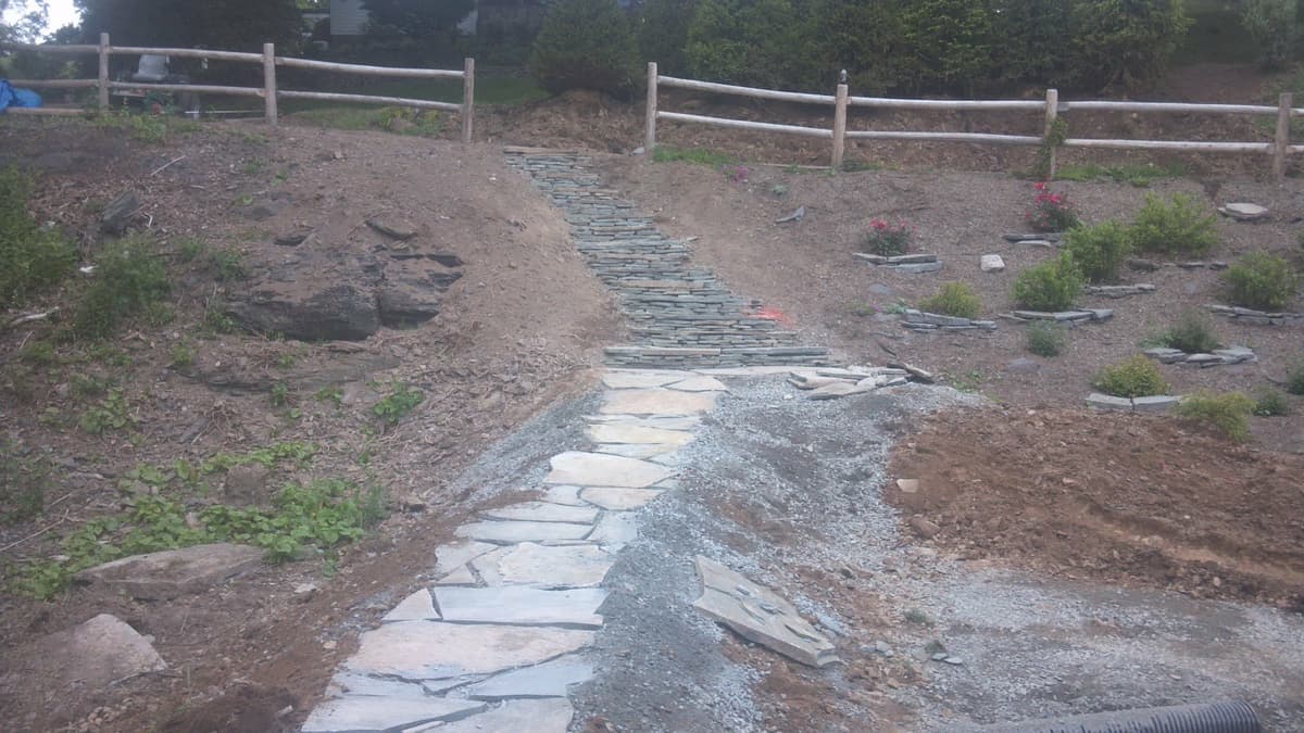 Stone walkway with split rail fence