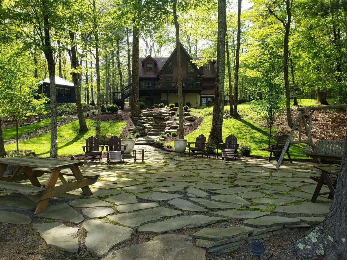 Flagstone patio with stone steps and Adirondack chairs