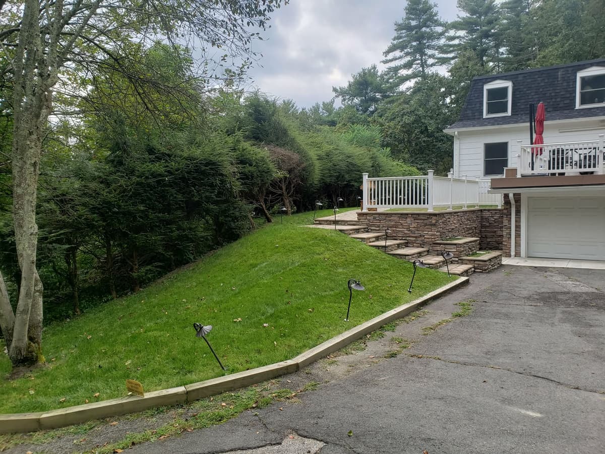Stone retaining wall with steps and landscaping