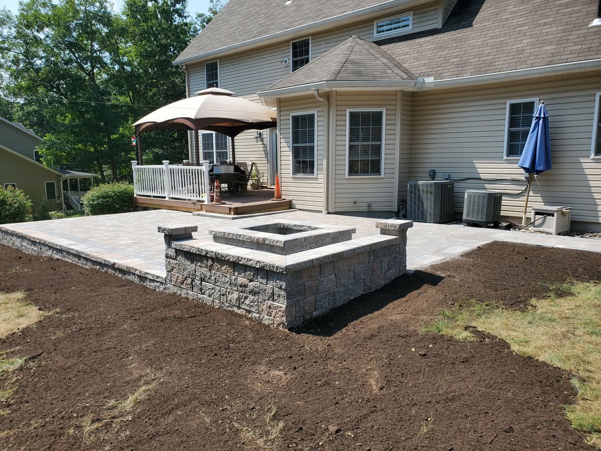 Paver patio with fire pit and seating wall